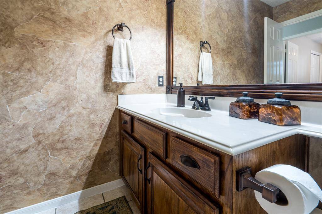 The secondary bath is well-appointed, and also features a tub/shower.