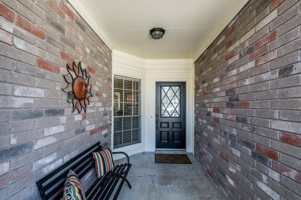 The entry to the home features a cool covered front porch - perfect for you to sit on and wave at the neighbors as they go on walks!