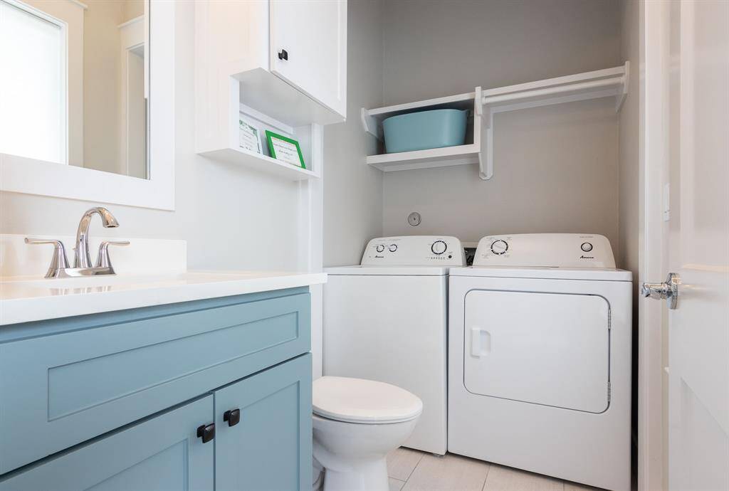 In house utility room located on the first level with a half bath and sink.  Full size washer and dryer.