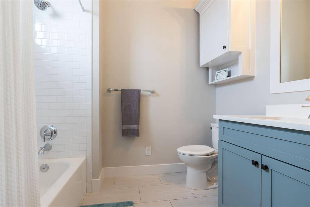 Private Guest  bathroom with tiled shower/tub combo on second floor.