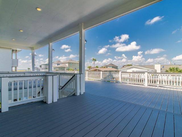 This spacious Trex deck features modern railings and stunning neighborhood views, perfect for relaxation and entertaining.