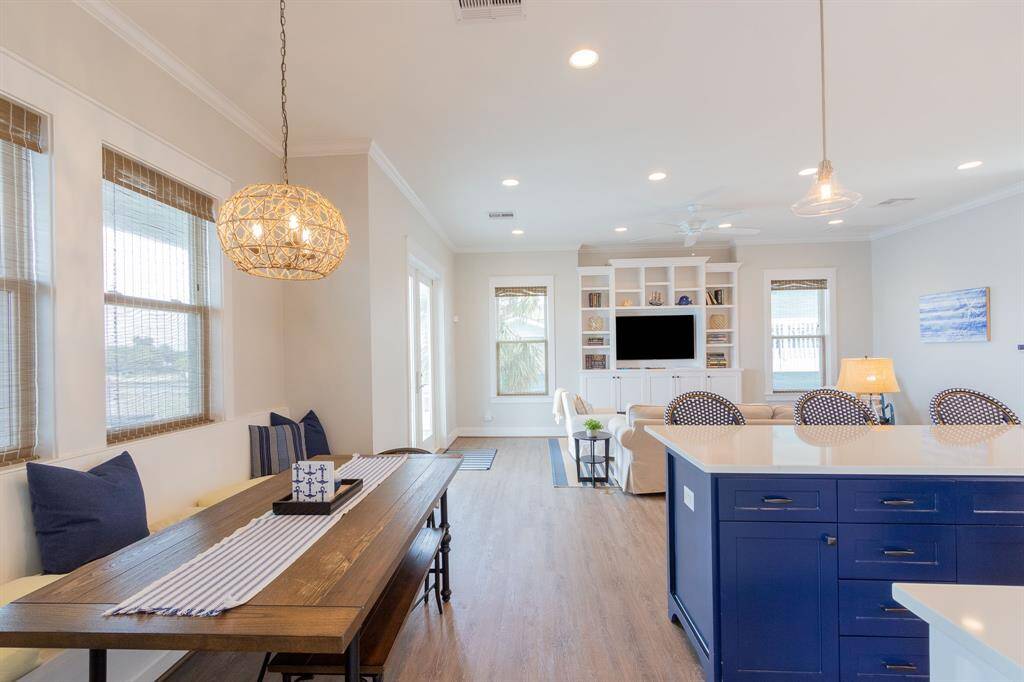 Open concept living/dining/kitchen with very high ceilings and recessed lighting.  Built in shelving in living room.