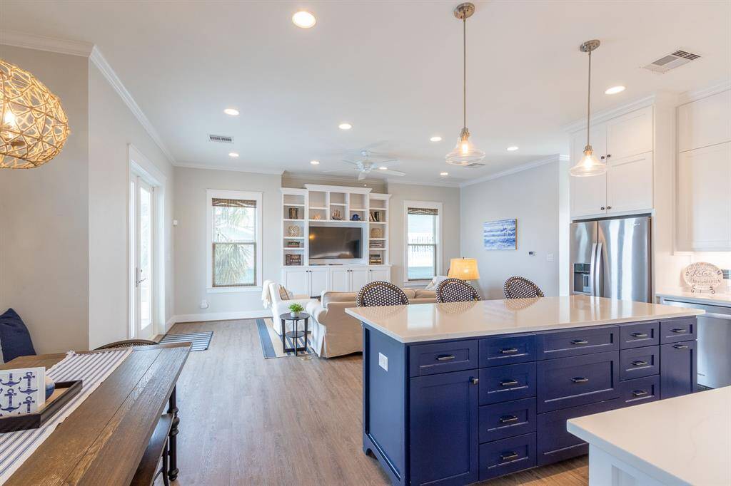 Open concept living/dining/kitchen with very high ceilings and recessed lighting.  Built in shelving in living room.