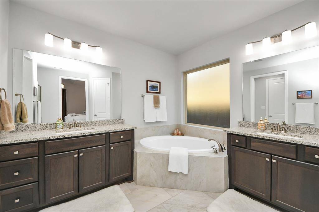 Primary bath with double sinks and inviting soaking tub