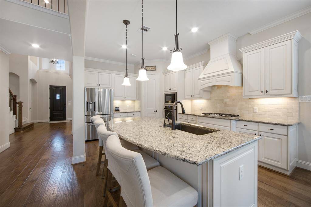 Granite island with undermount, spacious & deep single bowl sink. Sink features a water filtration system. Samsung refrigerator stays with property. Well maintained-sellers have had the HVAC systems checked out and serviced annually and they have flushed the water heaters annually as well.