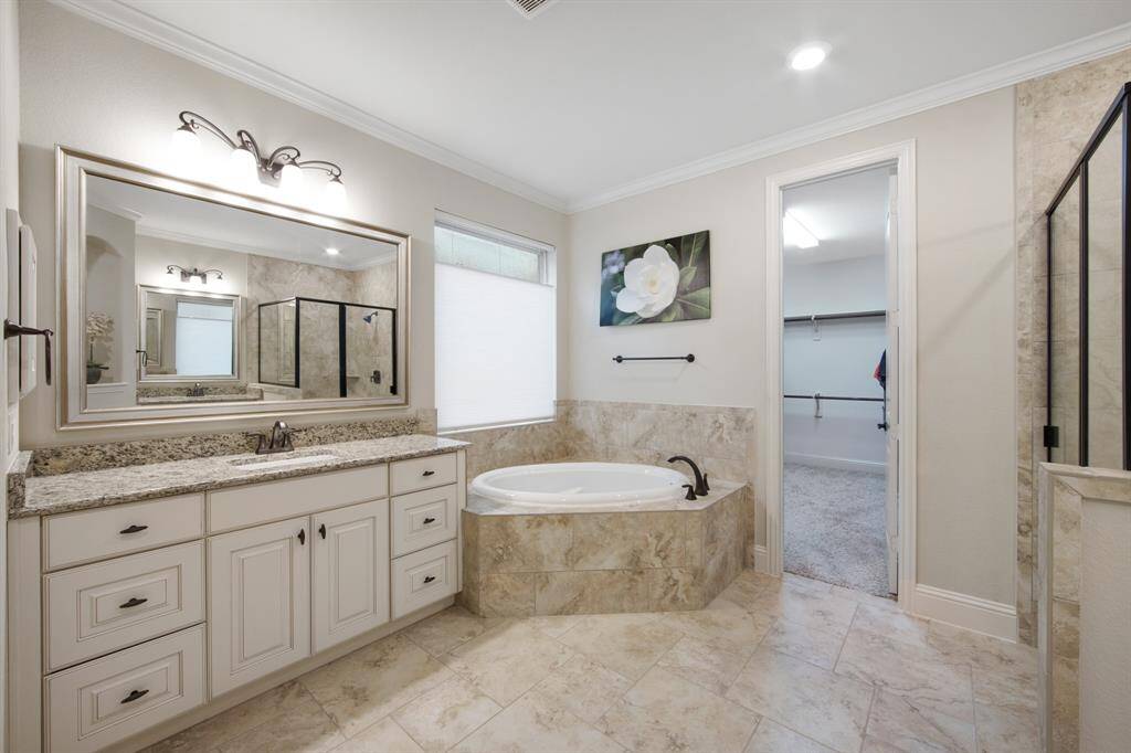 Owners bath features designer tile floor, tub skirt and surround. Oval garden tub, dual Granite counter tops with under counter sinks, 2 designer framed mirrors, two medicine cabinets and an opaque rain glass window. The walk-in closet is 12x11