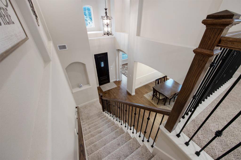 Multiple art niches and spaces to exhibit your art throughout this home. Dual stair wood railings and iron balusters