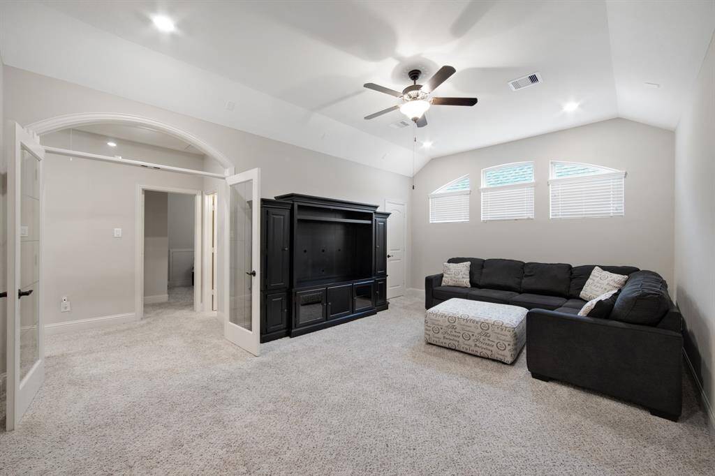 Game room/Media or enormous play room features V-Groove full lite French doors, canister lights and 5 blade ceiling fans and storage closet