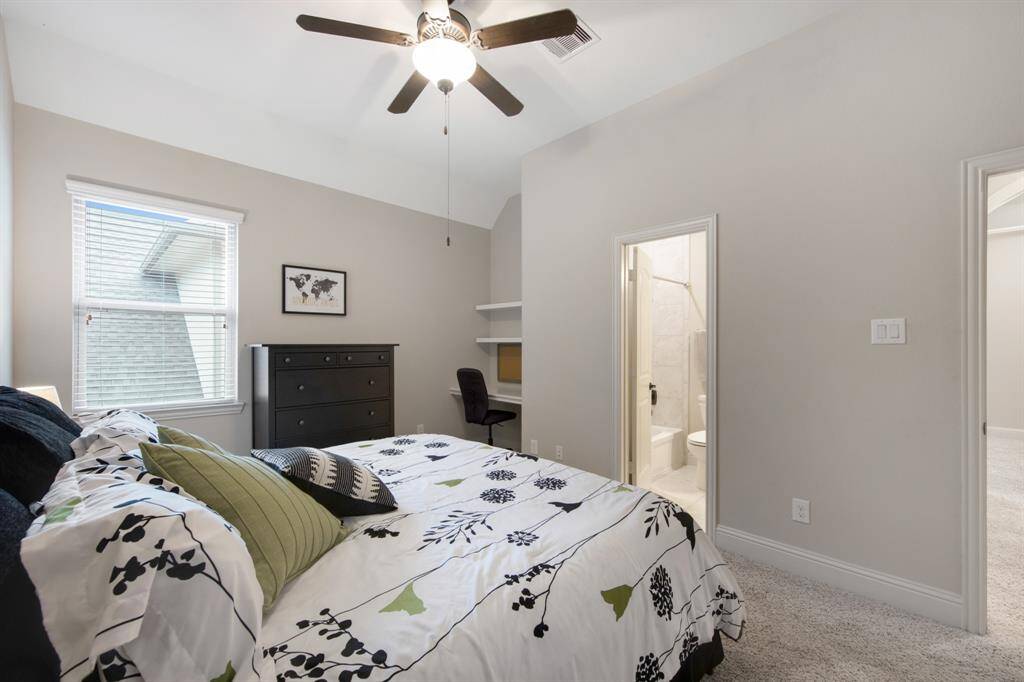 Up stairs bedroom features built-in work station and bathroom access