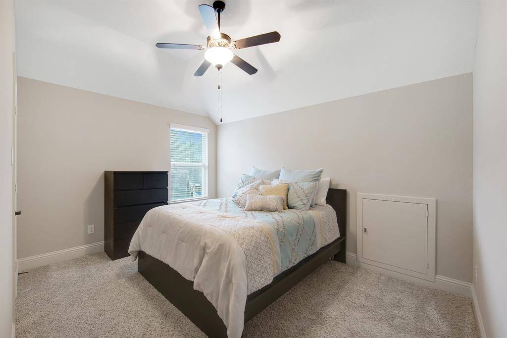 Second upstairs bedroom with 5 blade ceiling fan and plush carpet