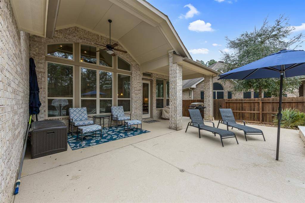 Large covered patio with 5 blade ceiling fan, gas line at patio, French drains and cool decking