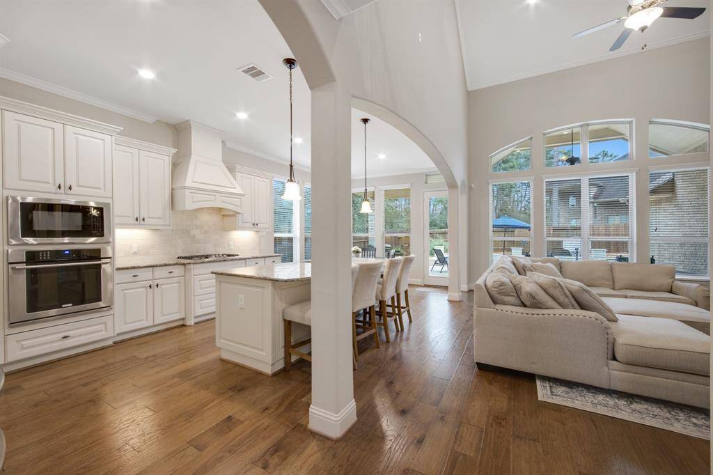 Large kitchen open to family room. Features 42" cabinets, with hardware, granite counter tops, undercabinet lighting