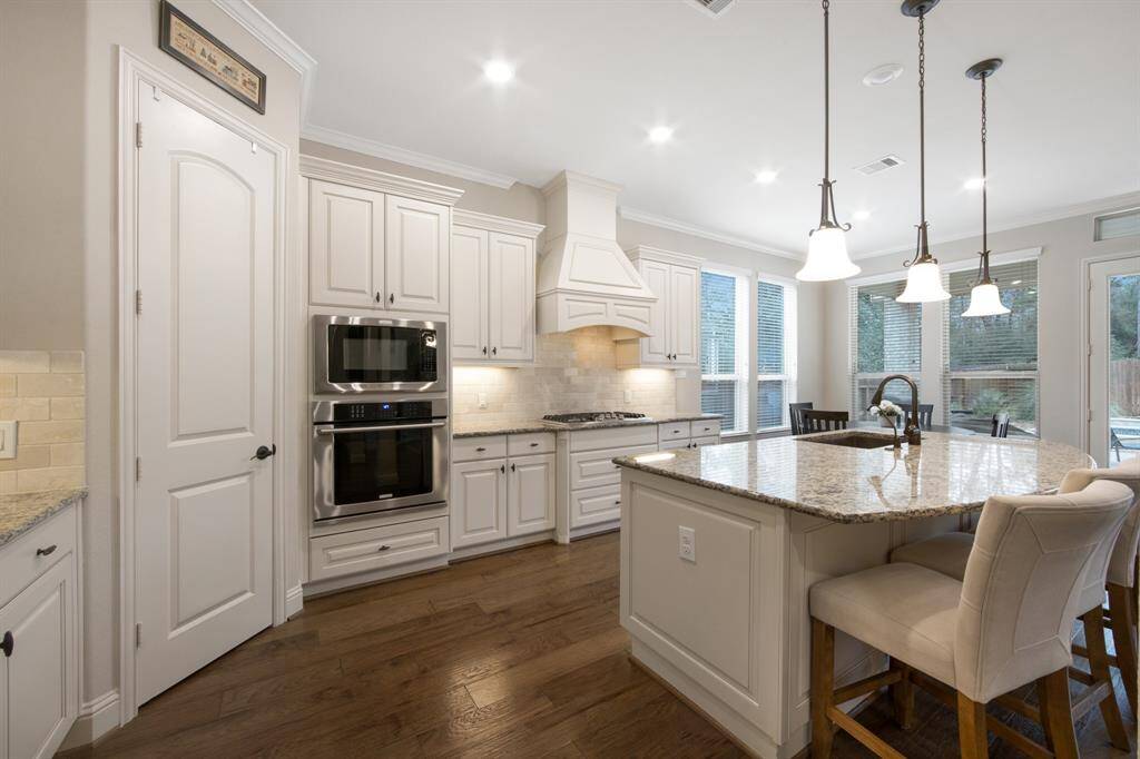 Kitchen with walk-in pantry,  30" Stainless steel self cleaning oven, stainless steel microwave and dishwasher