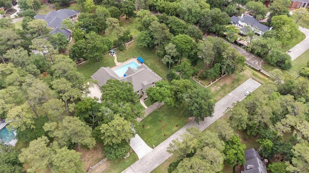 Experience ultimate privacy and tranquility in this stunning property featuring a spacious home, pristine pool, and expansive outdoor space. Surrounded by lush greenery and mature trees, it's nestled in a serene neighborhood.