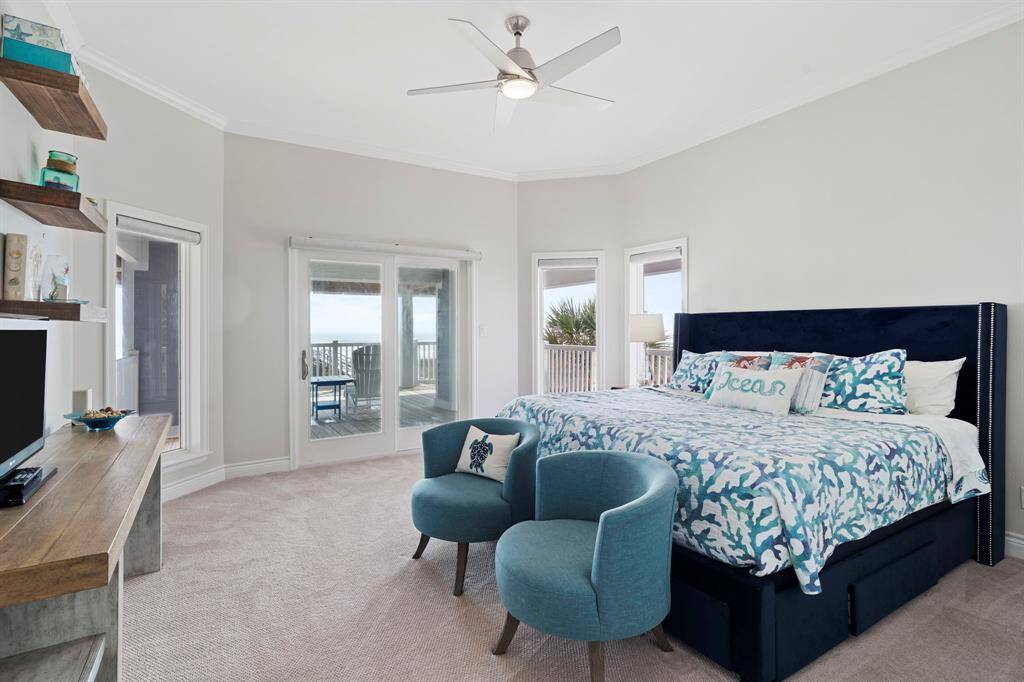 Third bedroom features large windows, plush carpet, and access to private balcony.