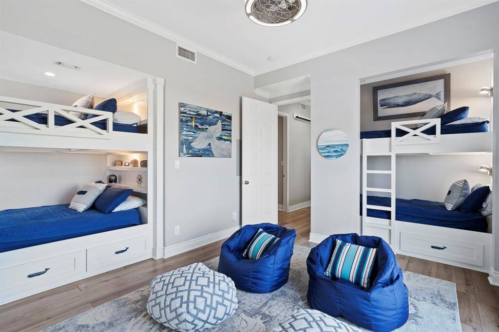 Fifth bedroom features large windows and access to private balcony.