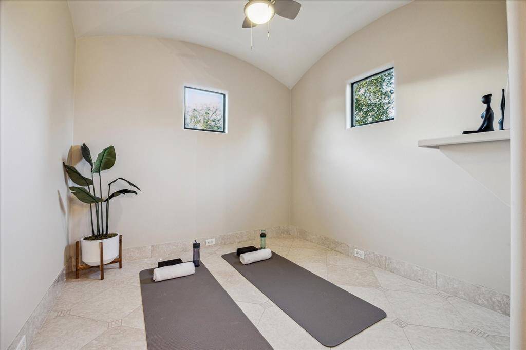 An exercise space/ flex room off the primary bath offers the perfect setting to start or end your day with ease and relaxation.