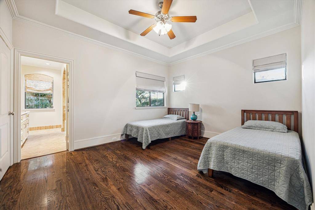 Third bedroom with hardwood floors, tray ceiling, walk-in closet and ensuite bathroom.