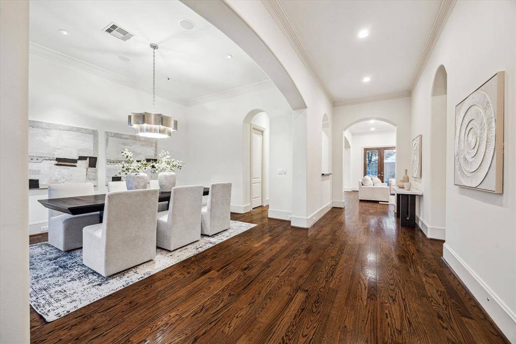 As you step inside, you'll be greeted by elegant hardwood floors, soaring ceilings and arched entryways.