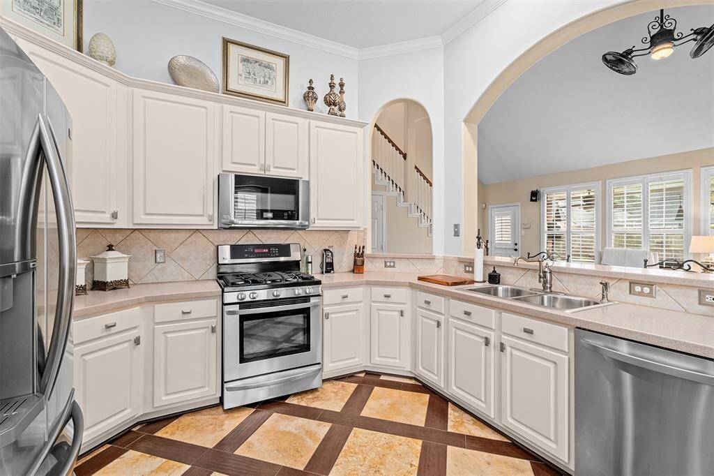 The elegant wood and tile floors feature exquisite designer details, creating a cohesive and stylish look.