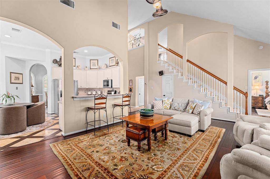 A spacious living room seamlessly connects to the kitchen.