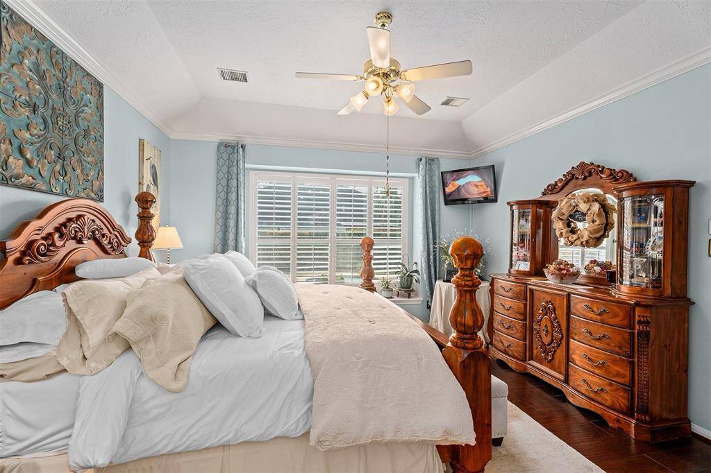 Luxurious crown molding complements the soothing paint color for an elegant touch.