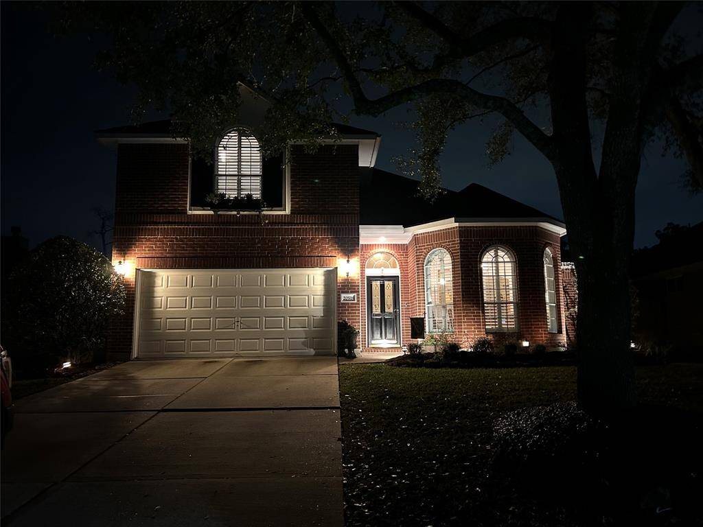 Beautifully landscaped with lighting in the front and back yard.