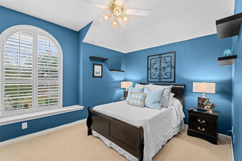 Bedroom features ceiling fan and a bonus walk-in closet.