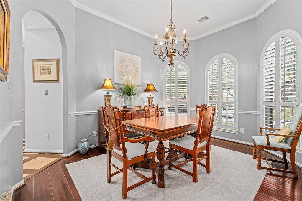 Elegant dining room with wood floors and a fabulous chandelier.