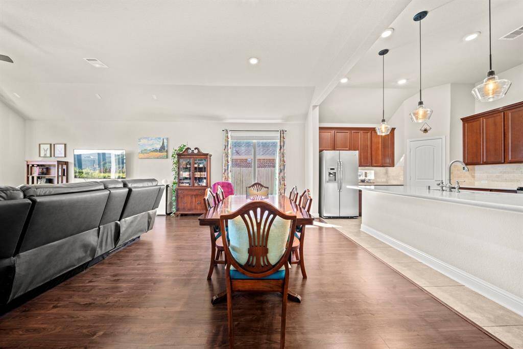 The lovely dining area adjoins the spacious living room.  Luxury vinyl plank flooring flows throughout this area.