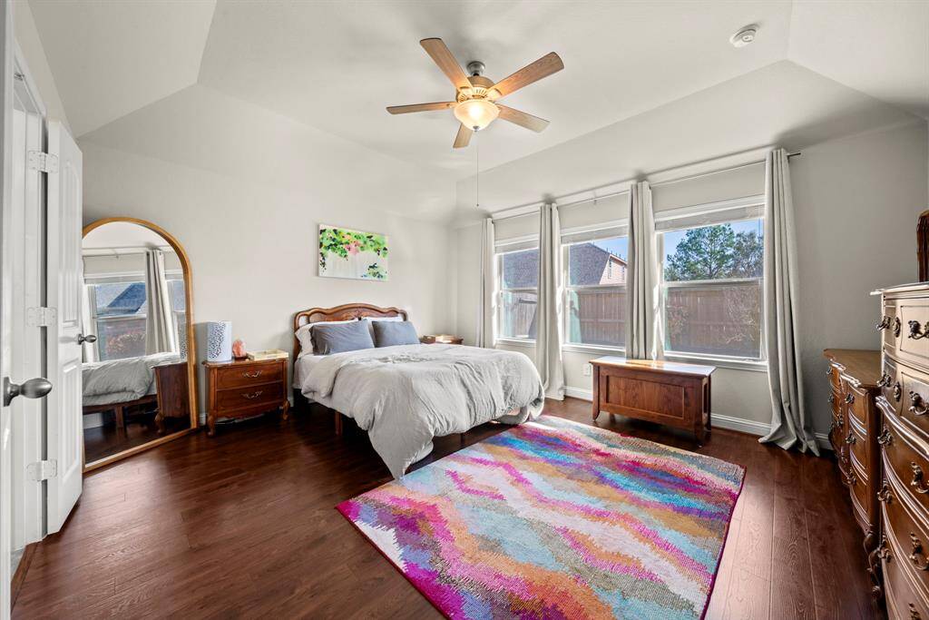 The king-sized master suite easily accommodates large furniture settings and is located separately from the home's secondary bedrooms, offering maximum privacy.