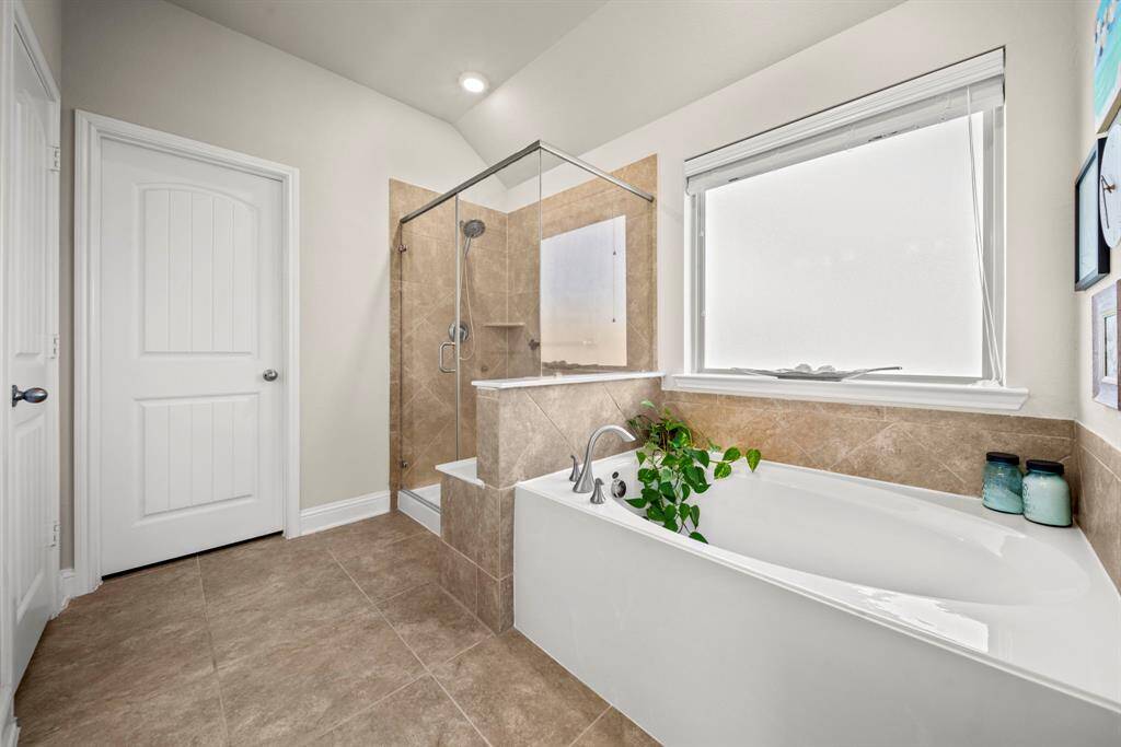 Lovely master bath, complete with dual sinks, garden tub & separate shower, linen closet, & large walk-in closet.