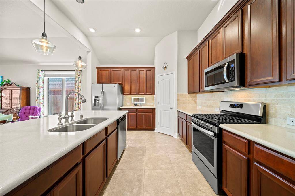 Island kitchen with silestone counters, 42" cabinetry, & stainless appliances