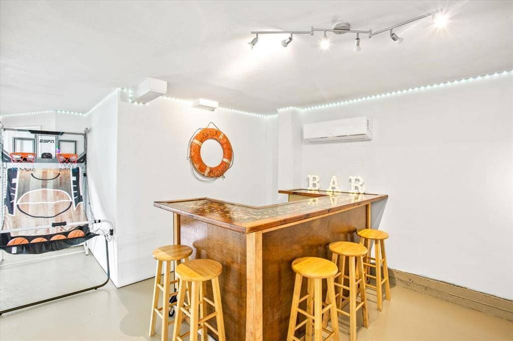 Downstairs is a large area designed for indoor outdoor living! It's party time games for the kids and a bar for the adults! Third bedroom is a bunk room with it's own bathroom.