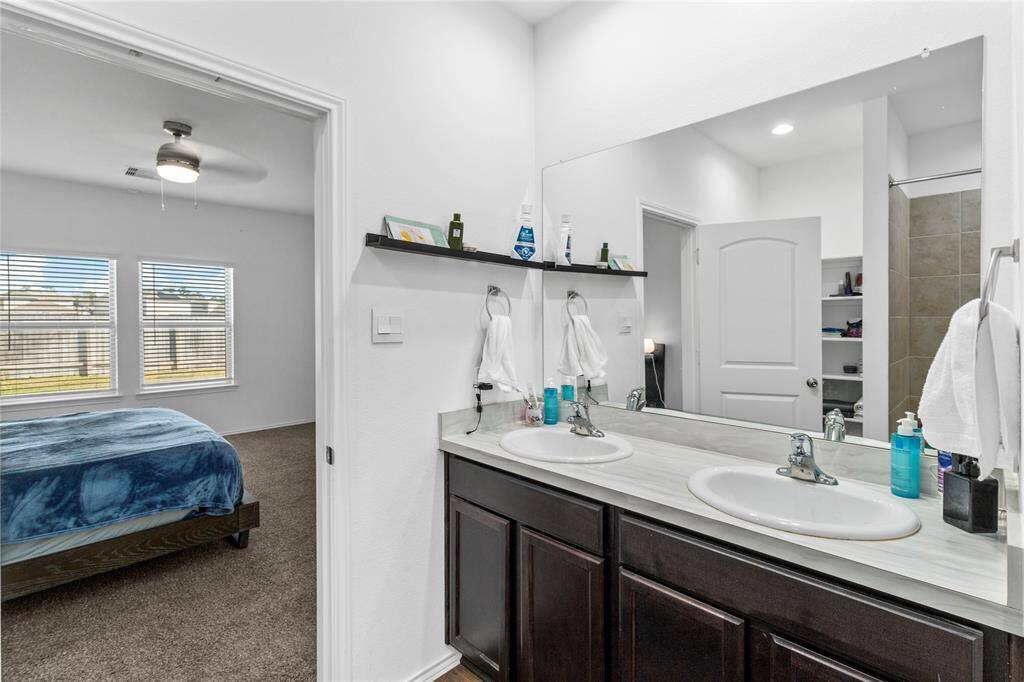 Double sinks with lots of counter space and tons of cabinet space.