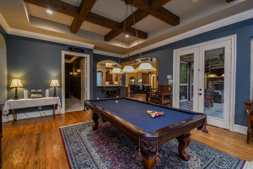 The game room has double doors that lead to the patio and is next to the media room.