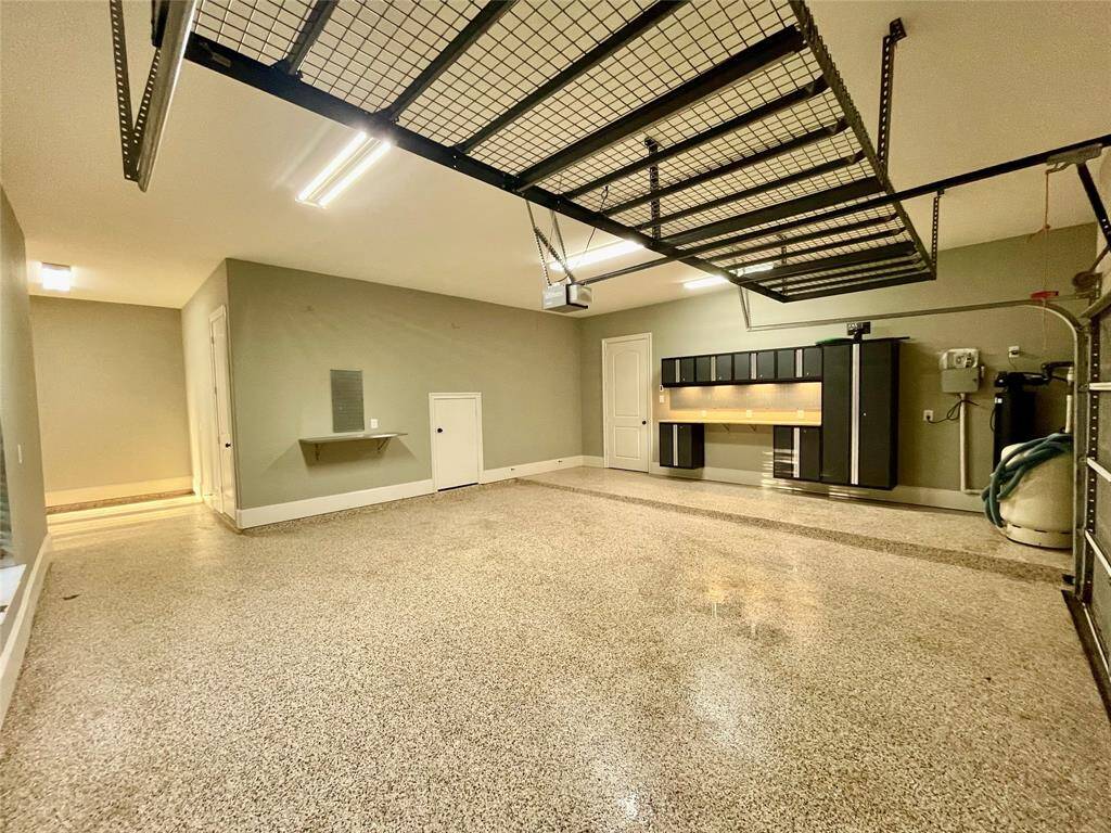 The second 2-car garage connects to the first and has an entrance to the third secondary bedroom. Ceiling rack and cabinets included with house.