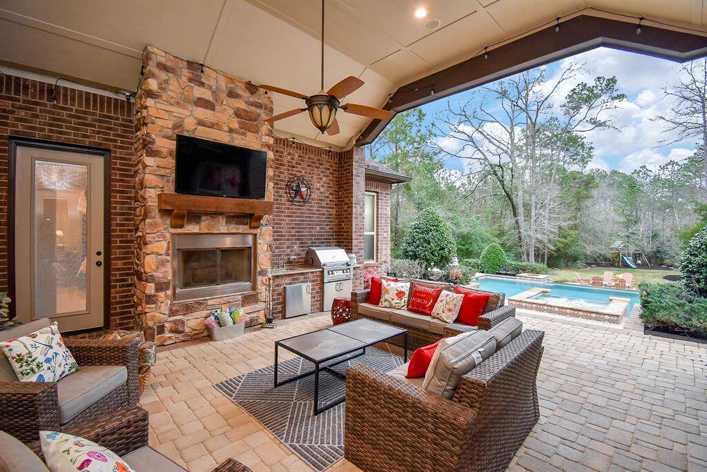 Outdoor patio features a fireplace and an outdoor kitchen. Everything you need for a cookout!