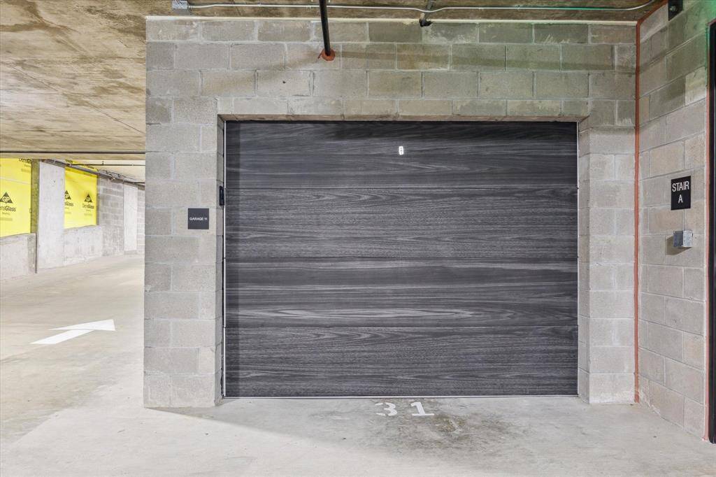 This is one of the two private garages for this penthouse unit. They each house a full size car with room for additional storage. The elevator with direct access to their home is located around the corner.