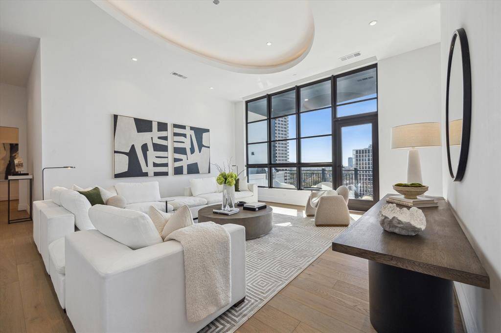 Designed for both comfort and style, this expansive space easily accommodates large-scale furnishings, creating an inviting setting for elegant entertaining or relaxed living. Cove lighting accentuates the architectural details while the 13 foot ceilings create an airy expansive feel.