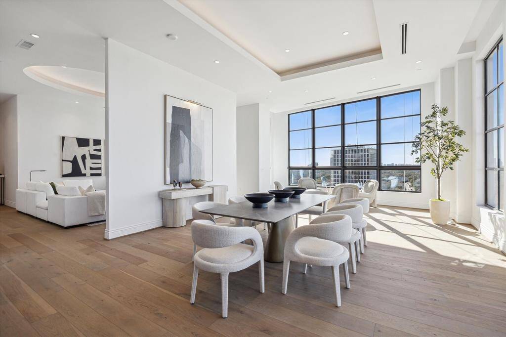 This photo captures the seamless flow of the living areas, highlighting the open concept design that defines this home. The spacious dining room flows into the inviting living room, emphasizing the interconnected layout that is perfect for both casual living and sophisticated entertaining.
