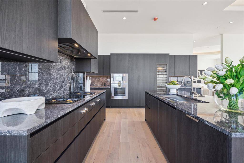 The kitchen is a perfect blend of high end finishes and clean lines. The sleek custom Eggersman cabinetry conceals the Gaggenau fridge, freezer and dishwasher. The cooktop has both gas and induction capability.