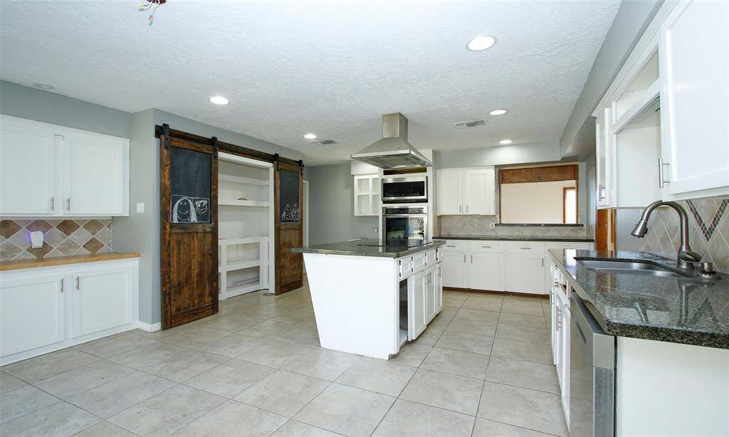 Kitchen features tile floors and is adjacent to the Dining Room.