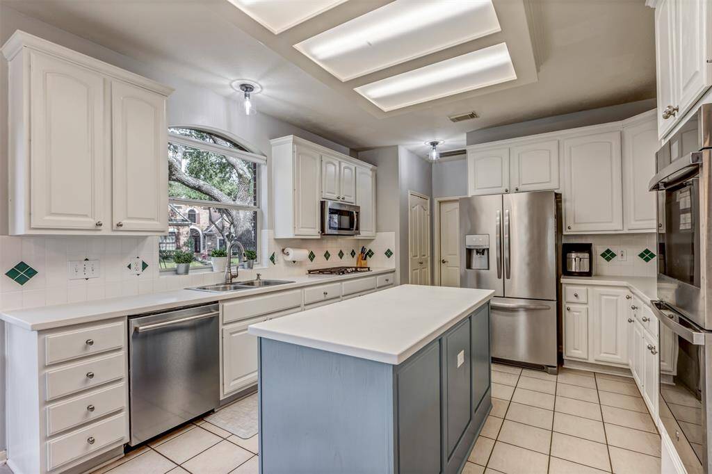 Resurfaced cabinets and island found in the large kitchen
