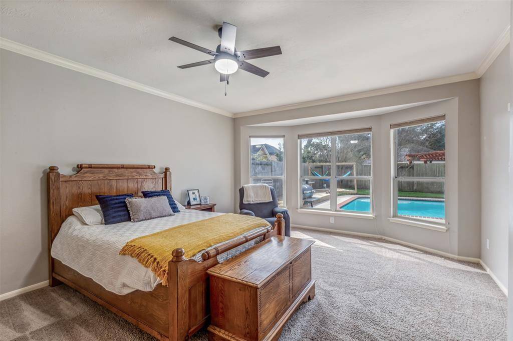 Large primary suite with extended bay window sitting area overlooking the fun backyard.