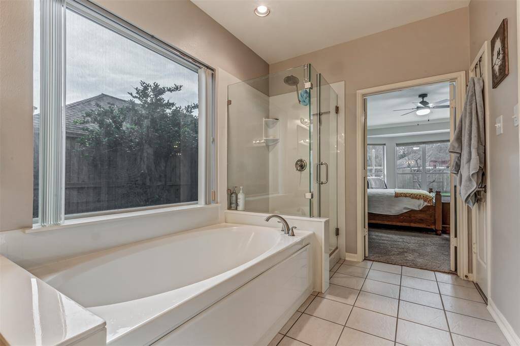 The large primary bath with a frameless shower enclosure and wonderful soaking tub.