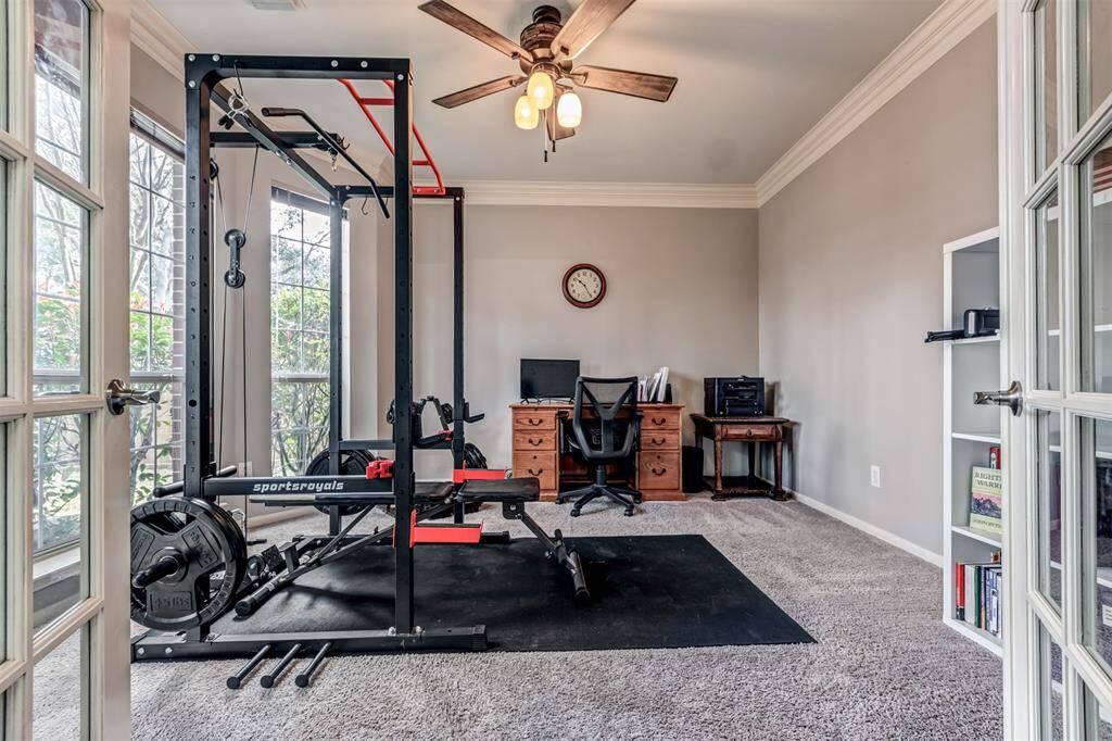 Behind the french doors we find the large office being utilized here as a home gym. Plenty of space for lots of options.