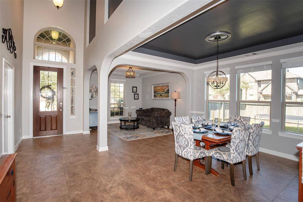 Natural light pours in through tall windows, highlighting the elegant architectural details.