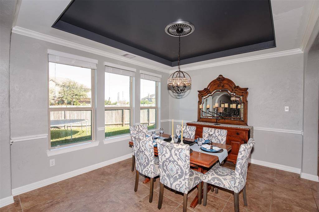 The formal dining room has a wonderful tray ceiling and the elegant crown molding.