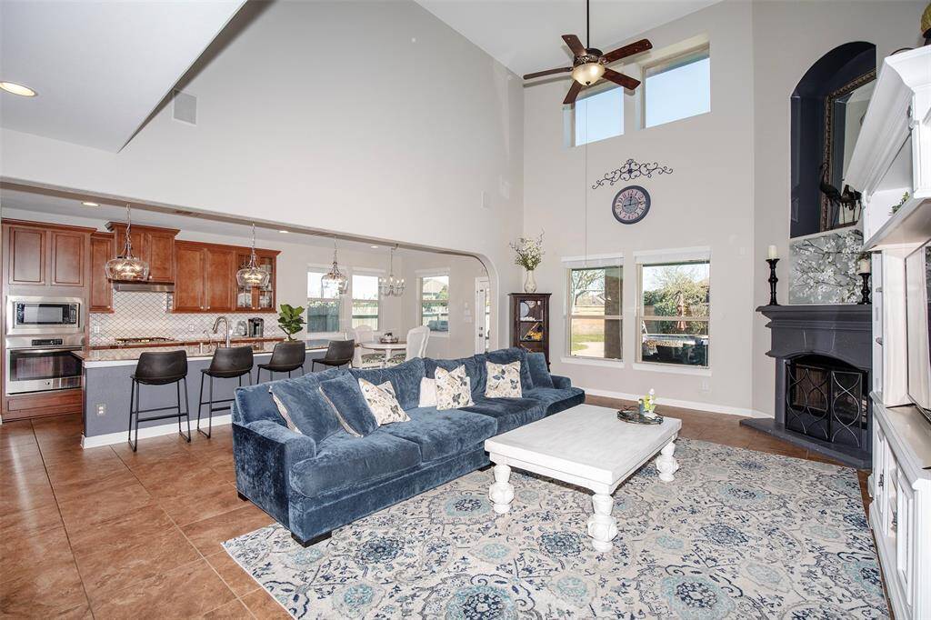 Towering windows flood the space with natural light, enhancing the open and airy feel.